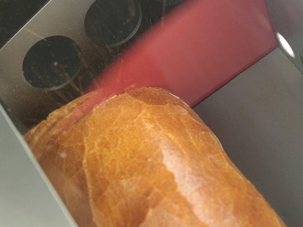 slicing bread in bread cutter